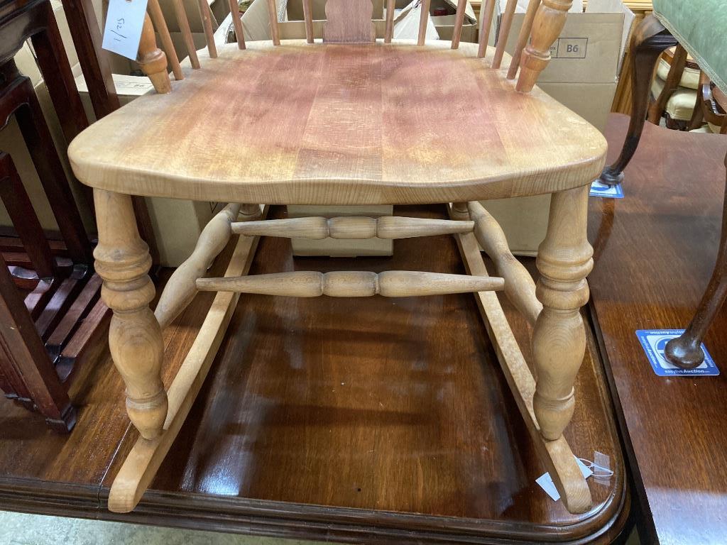 A reproduction beech Windsor rocking chair, width 63cm, depth 52cm, height 110cm